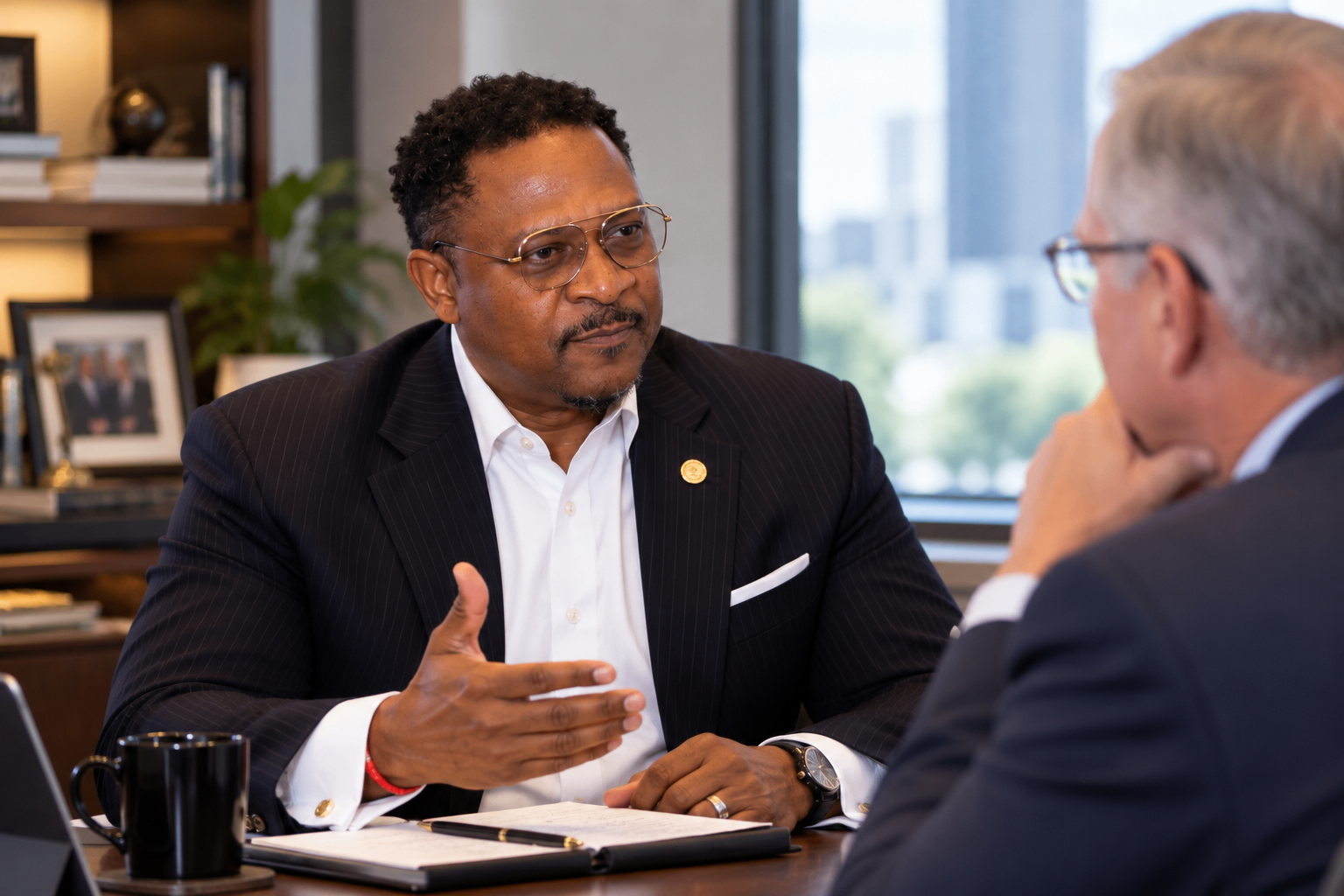 Galen Bingham in a one-on-one advisory conversation across the desk with a senior executive